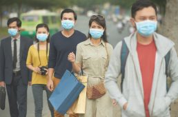 Citizens walking on the street in masks because of danger of epidemic